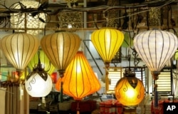 FILE - An array of paper lanterns hang in a display at Pearl River Mart, an emporium for Asian goods in New York. Items at the store range from teapots and ceramic goods to silk purses and Chinese musical instruments.