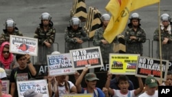 Protesters picket the headquarters of the Armed Forces of the Philippines to coincide with the opening ceremony of the joint U.S.-Philippines military exercise dubbed Balikatan 2014, in Quezon city, northeast of Manila, Philippines, on May 5, 2014.