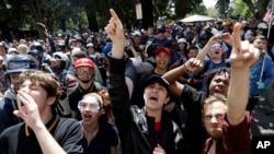 FILE - Demonstrators shout slogans directed at city hall during a rally for free speech Thursday, April 27, 2017, in Berkeley, Calif. (AP Photo/Marcio Jose Sanchez)