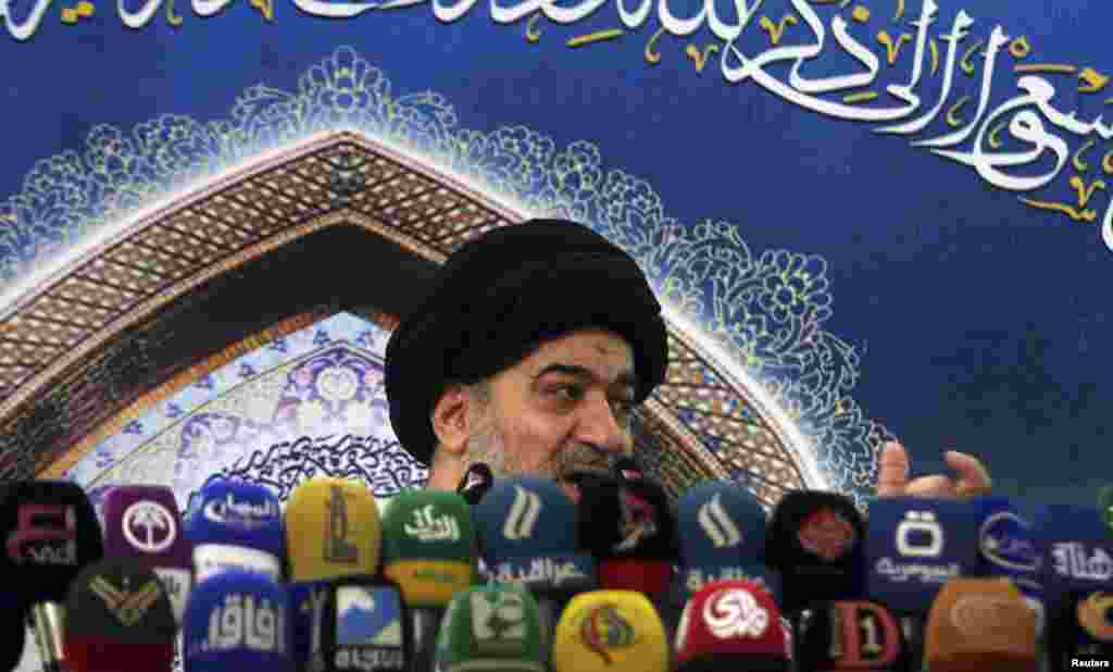 Iraqi cleric Ahmed al-Safi, an aide of Grand Ayatollah Ali Sistani, speaks as he delivers the text of a sermon by Sistani during Friday prayers, at the Imam Hussein shrine, in the holy city of Kerbala, Aug. 15, 2014.