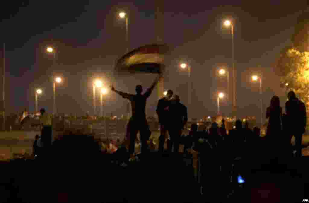 Anti-government protesters celebrate in the street in downtown Cairo, Egypt , Egypt Friday, Feb. 11, 2011. Fireworks burst over Tahrir Square and Egypt exploded with joy and tears of relief after pro-democracy protesters brought down President Hosni Mubar