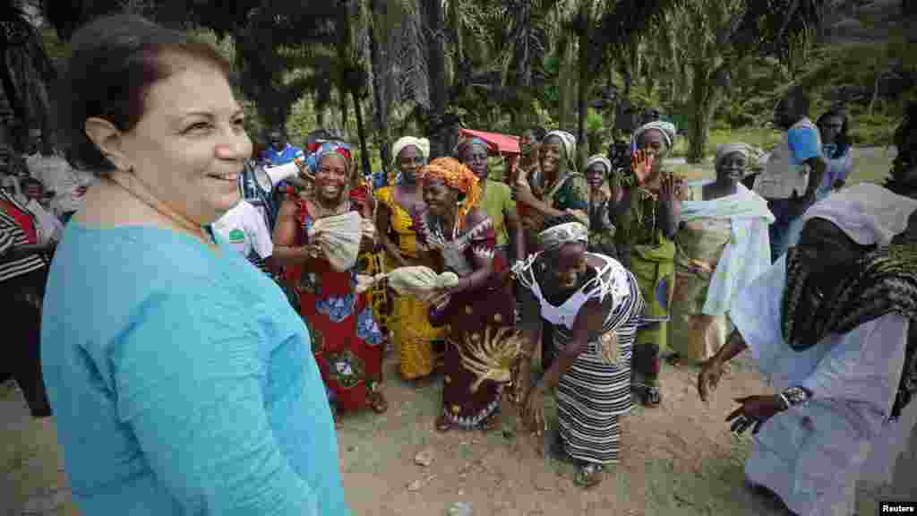 United Nations Children's Fund (UNICEF) Ivory Coast Representative Adele Khudr receives a welcome ceremony from the locals as she arrives for a Ebola awareness drive in Gueupleu, Man, in western Ivory Coast, Nov. 3, 2014. 