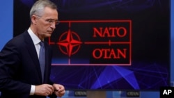 FILE - NATO Secretary General Jens Stoltenberg leaves after speaking at a media conference at NATO headquarters, in Brussels, Belgium, Jan. 12, 2022. 