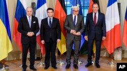 French Foreign Minister Laurent Fabius, Ukrainian Foreign Minister Pavlo Klimkin, German Foreign Minister Frank-Walter Steinmeier and Russian Foreign Minister Sergey Lavrov, from left, pose for a group photo at Villa Borsig, in Berlin, April 13, 2015