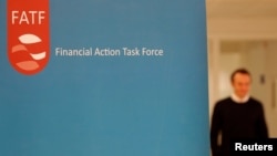 FILE - The logo of the Financial Action Task Force is seen during a news conference after a plenary session at the Organization for Economic Cooperation and Development headquarters in Paris, France, Oct. 18, 2019.
