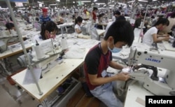 Laborers work at a garment factory in Bac Giang province, near Hanoi, Vietnam, Oct. 21, 2015.