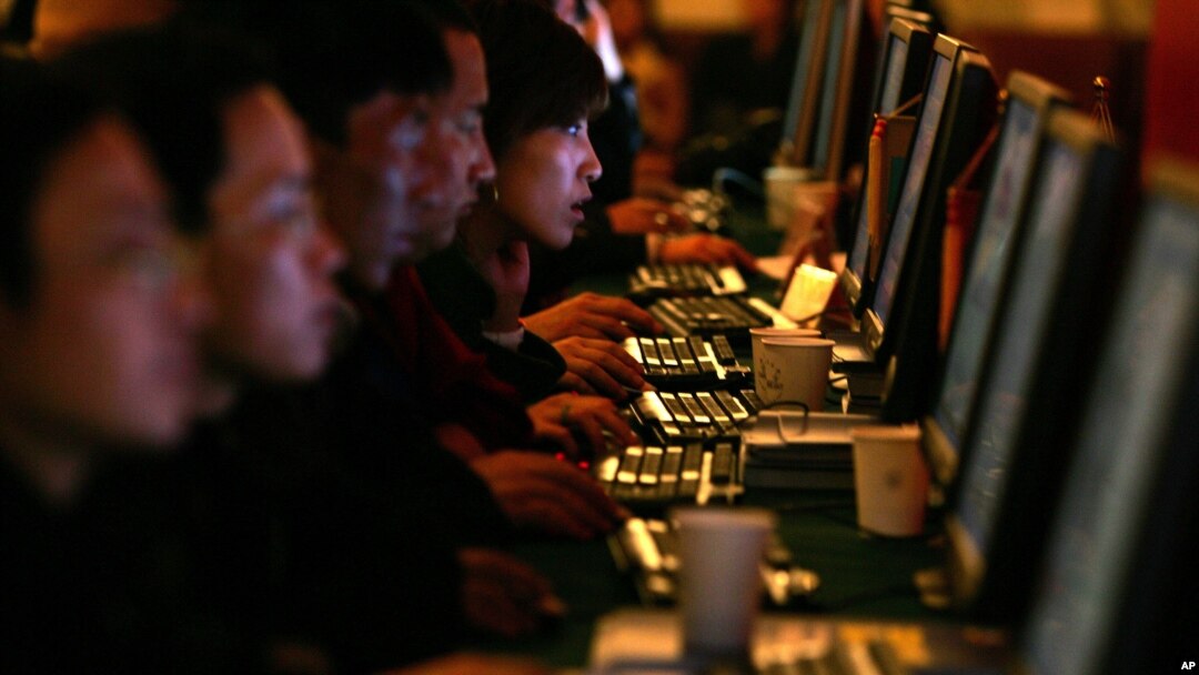 FILE - Chinese Web users are seen at computer workstations.