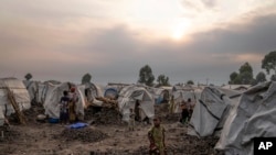 FILE - People displaced by the ongoing fighting gather at refugee camp on the outskirts of Goma, Democratic Republic of the Congo, July 11, 2024.