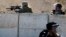 An Israeli security forces sniper aims his weapon toward Palestinian protesters during clashes in the east Jerusalem Arab neighborhood of Issawiya, Oct. 4, 2015.  