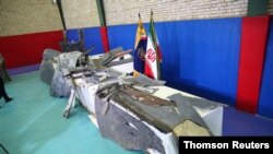 FILE - The purported wreckage of an American drone is seen displayed by the Islamic Revolutionary Guard Corps in Tehran, Iran, June 21, 2019.