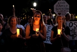 Immigration rights activists hold a "Lights for Liberty" rally and candle light vigil in front of the White House in Washington, July 12, 2019.