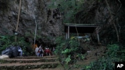 Rescue teams gather at the entrance of a deep cave where a group of boys went missing in Chiang Rai, northern Thailand, Monday, June 25, 2018. 