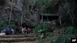 Rescue teams gather at the entrance of a deep cave where a group of boys went missing in Chiang Rai, northern Thailand, Monday, June 25, 2018. 