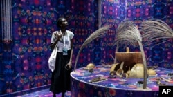 A visitor explores the international exhibit at the Dakar Biennale of Contemporary African Art in Dakar, Senegal, Nov. 8, 2024.