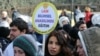 FILE - A woman holds a placard demanding "a secular and science-based education system" as hundreds of students and teachers march at a rally in Ankara, Feb. 13, 2015.