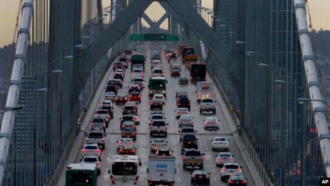 In this Dec. 10, 2015, file photo, vehicles make their way westbound on Interstate 80 across the San Francisco-Oakland Bay Bridge. California wants to fight the Trump administration's move to revoke the state's authority to set auto mileage standards. (AP Photo/Ben Margot, File)