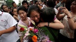 FILE - A Chinese student is greeted by a relative after taking the annual college entrance examinations in Beijing, June 8, 2010. Each year, about 10 million high school seniors across China take the "gaokao", the exam that is the sole determinant for whe