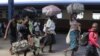 FILE: Women and children carry baggage at the main train station in Harare. (AP Photo/Tsvangirayi Mukwazhi)