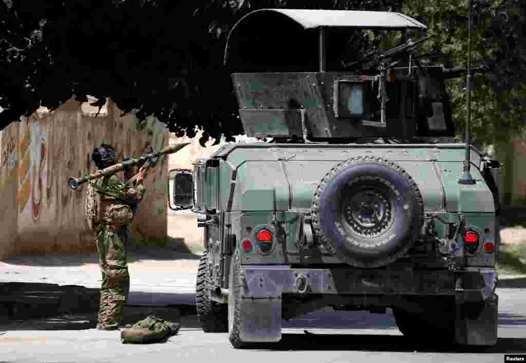 A member of the Afghan security forces prepares to fire an RPG during a battle with insurgents in Kabul.