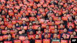 Lawmakers and members of opposition parties hold cards during a rally demanding the impeachment of South Korean President Park Geun-hye at the National Assembly in Seoul, South Korea, Dec. 7, 2016.