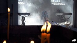 Church workers sweep the dust in the Holy Savior Cathedral, damaged by shelling by Azerbaijan's artillery during a military conflict in Shushi, the separatist region of Nagorno-Karabakh, Saturday, Oct. 24, 2020. The heavy shelling forced residents…