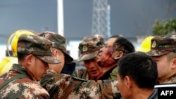 Paramilitary police officers transfer an injured man after an explosion in Yancheng in China's eastern Jiangsu province, March 21, 2019.