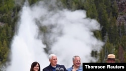 U.S. Vice President Mike Pence, with wife Karen, Interior Secretary David Bernhardt and Yellowstone National Park Superintendent Cam Sholly, speaks in front of Old Faithful Geyser in Yellowstone National Park in Wyoming, June 13, 2019. 