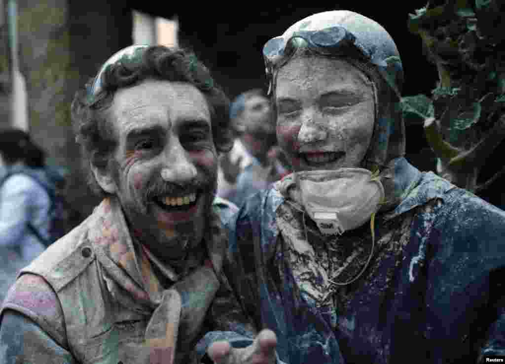 People after a flour fight in Laza Village, Spain.