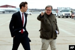FILE - Jared Kushner, son in-law of President-elect Donald Trump, left, walks with Trump's Chief Strategist Stephen Bannon at Indianapolis International Airport, Dec. 1, 2016.