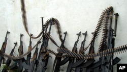 Kalashnikov assault rifles and heavy machine guns are lined up against a wall at one of Mogadishu's four open-air markets.
