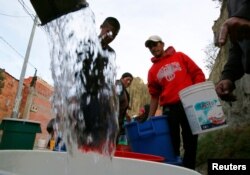 Neighbors get water from a water truck in Kupini, La Paz, Bolivia, Nov. 17, 2016.