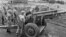 Gen. Maxwell Taylor, President John F. Kennedy's special military adviser, examines a South Vietnamese cannon during a tour of the border between North and South Vietnam, Oct. 22, 1961.