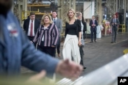 FILE - Ivanka Trump, daughter of then-Republican presidential candidate Donald Trump, center, tours Middletown Tube Works, a welded steel tube supplier, alongside owner Angela Phillips, left, in Middletown, Ohio, Oct. 6, 2016.