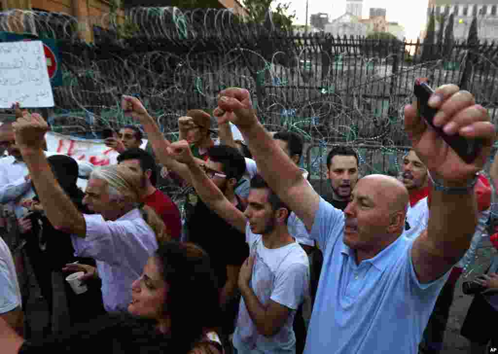 Lebanese anti-government protesters demonstrate against the trash crisis and government corruption near the government building, in downtown Beirut, Sept. 2, 2015.