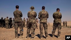 FILE - In this 2013 photo, U.S. special operations forces watch forces from Iraq, Jordan and Lebanon during a multinational military exercise in Zarqa, Jordan.