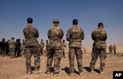 FILE - In this 2013 photo, U.S. special operations forces watch forces from Iraq, Jordan, and Lebanon during a multinational military exercise in Zarqa, Jordan.