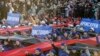 Performers hold banners with names of Crimean cities during celebrations marking the first anniversary of Russia's annexation of Ukraine's Black Sea peninsula of Crimea, in central Simferopol, March 16, 2015. The placards read (L-R), "Yevpatoriya," "Sevastopol" and "Bakhchisaray."