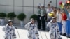 China's astronauts from left Liu Yang, Jing Haipeng and Liu Wang salute before they depart for the Shenzhou 9 spacecraft rocket launch pad at the Jiuquan Satellite Launch Center in Jiuquan, China, Saturday, June 16, 2012.