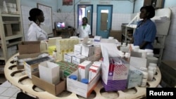 Nurses work in the pharmacy at the general hospital in Man, western Ivory Coast, July 4, 2013. 