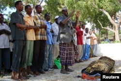 FILE - A Muslim sheikh leads prayers for slain journalist Sa'id Tahlil Ahmed, head of private media house Horn Afrik in Mogadishu, Feb. 5, 2009. Gunmen shot Ahmed in Mogadishu's Bakara market, which is often a battleground for government soldiers and Islamist insurgents, witnesses and colleagues said.