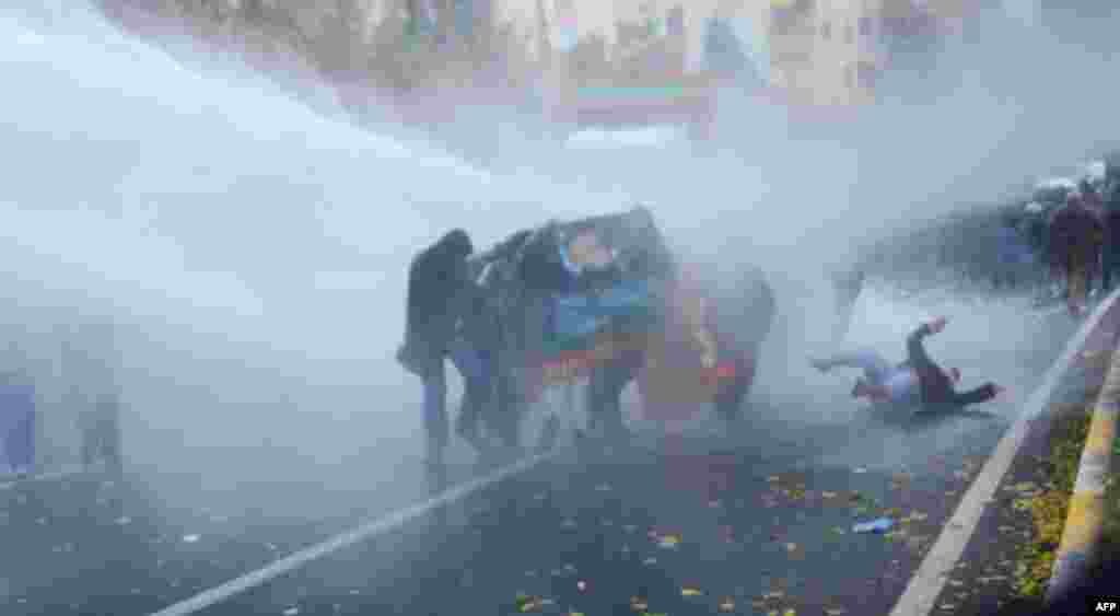 A Kurdish protester falls to the ground as Turkish riot police use water cannons to disperse them during a demonstration in Diyarbakir. Tensions remain high in Diyarbakir after the death of two Kurdish demonstrators on Dec. 6.