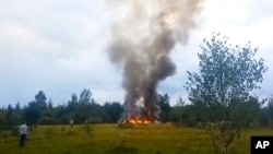 FILE - Smoke rises from the crash of a private jet near the village of Kuzhenkino, Russia, on Aug. 23, 2023. Mercenary leader Yevgeny Prigozhin, head of the Wagner Group, and his top lieutenants were among the 10 people killed in the crash.