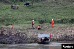 FILE - A Chinese team of geologists surveys the Mekong River banks, at the Laos side, at the border between Laos and Thailand, April 23, 2017.