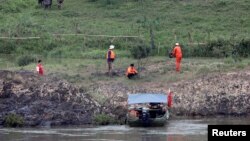 FILE - A Chinese team of geologists surveys the Mekong River banks, at the Laos side, at the border between Laos and Thailand, April 23, 2017. 