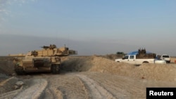 Iraqi security forces military vehicles are seen during an intensive security deployment against Islamic State militants in the town of Amriyat al-Falluja,in Anbar province, Oct. 31, 2014.