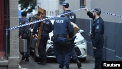 FILE - Police raid a property in the Sydney suburb of Surry Hills, Australia, July 31, 2017, in the wake of a plot again Australia's aviation sector.