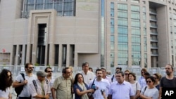 Journalist are seen gathered outside a court building to support a colleague who was detained in connection with the investigation launched into the recent failed coup attempt in Turkey, in Istanbul, July 27, 2016.