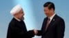 Iran's President Hassan Rouhani, left, shakes hands with his Chinese counterpart Xi Jinping at the fourth Conference on Interaction and Confidence Building Measures in Asia summit in Shanghai, May 21, 2014. The two will meet again on the sidelines of the Eurasian Shanghai Cooperation Organization meeting in June. 