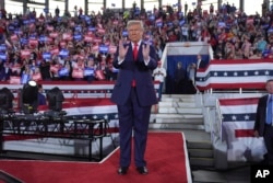 Republican presidential nominee former President Donald Trump arrives to speak at a campaign rally at J.S. Dorton Arena, Monday, Nov. 4, 2024, in Raleigh, N.C. (AP Photo/Evan Vucci)