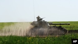 An armored Russian vehicle rides during a training exercise at the Kuzminsky military training ground outside the village of Chkalovo near the Russian-Ukrainian border, in the Rostov region, Russia, May 25, 2015.